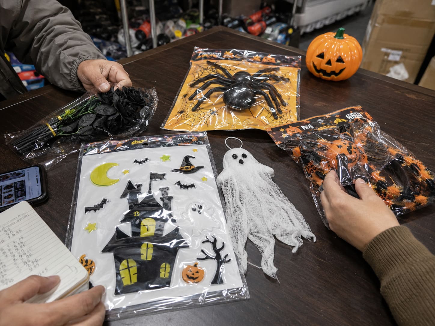 Yiwu sample room with Halloween products spread across a work table for comparison and supplier selection review
